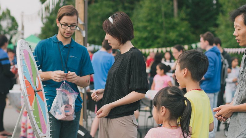 spinning a prize wheel at an outdoor party